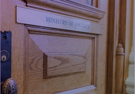 Report cover image showing a wooden door with the Ministry of Finance placard across it